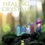"HEALING CRYSTALS", "CALENDAR 2026". Fünf Kristalle auf Moos mit grünem Schmetterling, unscharfer Waldhintergrund.