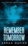 Text: "ONCE YOU’RE TAKEN, THERE’S NO COMING BACK", "REMEMBER TOMORROW", "ARRAN DAVIES". Gesicht in Wolken über einer düsteren Stadt.