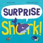 Text: "SURPRISE Shark!" Ein Hai mit großen Augen, umgeben von bunten Meeresfischen in leuchtend blauem Wasser., Buch