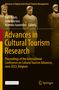 Aufschrift: "Advances in Cultural Tourism Research". Drei altertümliche Skulpturen vor dunklem Hintergrund., Buch