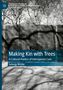 Buchtitel: "Making Kin with Trees". Bäume im Hintergrund, Schatten fallen auf eine Mauer., Buch