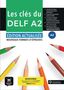 "Les clés du DELF A2", grüne Fläche, Buntstifte in verschiedenen Farben, Logo unten links, MP3-Hinweis unten rechts., Buch