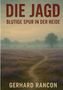 Text: "DIE JAGD: BLUTIGE SPUR IN DER HEIDE" von "GERHARD RANCON". Eine Nebellandschaft mit Heidekraut und einem Baum., Buch