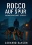 "ROCCO AUF SPUR - WENN DUNKELHEIT SPRICHT" von Gerhard Rancon. Ein Hund auf Kopfsteinpflaster, Silhouette eines Mannes im Hintergrund., Buch