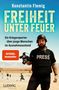 Text: „Konstantin Flemig, Freiheit unter Feuer, Ein Kriegsreporter über junge Menschen im Ausnahmezustand.“ Ein Fotograf mit Kamera in einer Wüste., Buch
