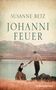 „Johanni Feuer“ von Susanne Betz. Zwei Personen an einem See, umgeben von Bergen. Eine Frau reicht einem Mann die Hand., Buch