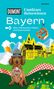 Buchtitel: "Unnützes Reisewissen Bayern", mit Dackel, Brezel und bayerischem Schloss vor Alpenhintergrund., Buch