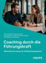 "Coaching durch die Führungskraft" steht in Weiß auf Türkis, darunter zwei Personen im Gespräch an einem Tisch., Buch