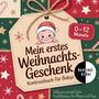 "Mein erstes Weihnachtsgeschenk" auf einem Geschenkanhänger mit Baby in Weihnachtsmütze, Geschenkpapier., Buch