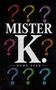 "MISTER K.", "DOMÈ STÀN". Illustration mit bunten Fragezeichen auf schwarzem Hintergrund., Buch