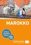 Text "MAROKKO". Darunter gehen verschleierte Frauen vor einer Wand mit großem Gesichtsgraffiti. Hinweis auf Reisehandbuch.