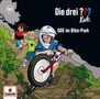 Aufschrift: "Die drei ??? Kids", "SOS im Bike-Park". Illustration von drei Kindern, eines auf einem Fahrrad im Gelände., CD