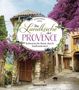 Die Worte auf einer Tafel lauten "Die Landküche der Provence: Kulinarische Reise durch Südfrankreich". Im Hintergrund ein malerisches Dorf mit Blumen., Buch