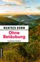 "Manfred Bomm, Ohne Betäubung, Kriminalroman." Landschaft mit Hügeln, Wald und einem Dorf im Tal bei Sonnenuntergang., Buch