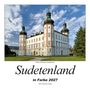 „Sudetenland in Farbe 2027“. Darunter ein Schloss mit Türmen, blauem Himmel und Wolken.