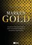 Text: "Marken Gold" und "Die geheime Währung des Erfolgs..." auf gemustertem Hintergrund. Unten Logo: "Mentoren Verlag"., Buch