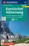 KOMPASS Wanderführer: Karnischer Höhenweg, 28 Touren. Bild zeigt Wanderer vor beeindruckender Berglandschaft., Buch