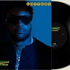 Der Text lautet „LOTTERY“ oben und „SHAGGY“ unten. Ein Mann mit Sonnenbrille blickt ernst, daneben eine Schallplatte.