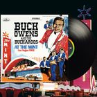 Text: "Buck Owens and The Buckaroos at The Mint Las Vegas 1968". Illustration: Bandmitglieder in blauen Anzügen, Vintage-Stil.
