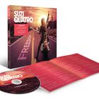 Texte: "SUZI QUATRO FREEDOM" und Liedtitel. Eine Frau auf einem Motorrad auf einer Straße in einer Wüstenlandschaft.