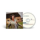 „Paradies“, Felix Meyer & project île. Ein Mann lacht vor einem alten Gebäude. CD und Cover sichtbar.
