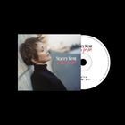 Text: "Stacey Kent, a Time for Love". Eine Frau lehnt entspannt an einer Wand, mit geschlossenen Augen und kurzem Haar. CD sichtbar.