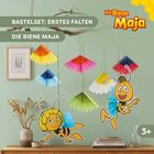 "Bastelset: Erstes Falten, Die Biene Maja" steht über einer Szene mit bunten Papierfächern und einer Biene Maja Illustration.