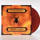 Text: "16 Horsepower", "Secret South". Orange Hintergrund, darauf eine schwarze Spinne, Design im Retro-Stil.