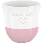 Text: "SCHWESTERHERZ". Ein weißer Becher mit rosa unterem Bereich und einem Herzmotiv darunter.