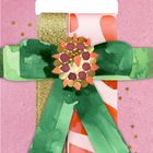 "Coppenrath schöner schenken", auf rosa Hintergrund mit goldenen Punkten, grüne Schleife und dekoratives Muster.