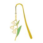 Eine goldene Lesezeichenform mit einem stilisierten Maiglöckchen-Anhänger, bestehend aus weißen Blüten und grünen Blättern.