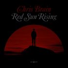 „Chris Brain, Red Sun Rising“ steht in stilvoller Schrift. Silhouette einer Person vor rotem Sonnenuntergang.