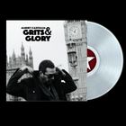 Text: ALBERT CASTIGLIA - GRITS & GLORY. Schwarz-weißes Foto eines Mannes vor Big Ben, transparenter Vinyl-Schallplatte.