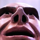 Ein übergroßes Gesicht schaut nach oben, der Fokus liegt auf der Nase und dem Mund.