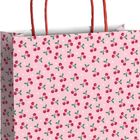 Rosafarbene Geschenktüte mit Kirschmuster und roten Griffen.