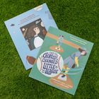 Zwei Kinderbücher auf Gras zeigen Baseball-Themen. Oben: "The true story of Maria Pepe," unten: "The Girl Who Changed Little League."