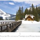 Text: „Emerald Lake, Canadian Rockies“. Eine Hütte am verschneiten See mit Berglandschaft und Bäumen im Hintergrund.