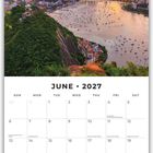 Text: "June 2027". Kalender mit Foto einer Stadt, Berg im Hintergrund, unter dramatischem orange-gelbem Himmel bei Sonnenuntergang.