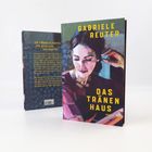 Titel: "Das Tränenhaus" von Gabriele Reuter. Illustration einer nachdenklichen Frau, Hände am Kopf, auf Buchcover.