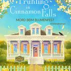 „Frühling in Cinnamon Falls“, „Mord beim Blumenfest: Kriminalroman“. Gelbes Haus mit Blumen, blauer Himmel.