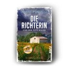 „LILIANE FONTAINE: DIE RICHTERIN UND DER TOTE MALER.“ Ein Feld mit Sonnenblumen, ein Weg zu einem Steinhaus.