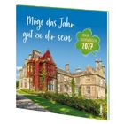 „Möge das Jahr gut zu dir sein. Irische Segenswünsche 2027“. Alte Villa von Efeu überwuchert vor klarem Himmel.