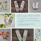 "Gute Laune für Hände und Füße: 18 neue Motive, bebilderter Strickkurs, leserliche Charts." Verschiedene bunte Stricksocken.
