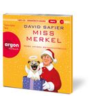"David Safier MISS MERKEL MORD UNTERM WEIHNACHTSBAUM", Illustration: Frau in rotem Mantel, Hund mit Flügeln in Geschenkbox.