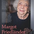 Text: "Ich bin zurückgekommen..." – Margot Friedländer. Porträt einer älteren Dame mit einem sanften Lächeln.