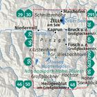 Text: KOMPASS (oben links in einem Logo). Zwei Hände zeigen auf eine ausgebreitete Landkarte auf einem Holztisch.