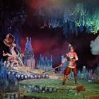 Illustration einer surrealen Szene mit Krieger, umgeben von Schädeln und einem riesigen Pflanzenwesen in fantasievoller Landschaft.