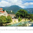 Text: "Meran", "10"
Ein Fluss fließt durch eine Stadt mit historischen Gebäuden, umgeben von Bergen und Bäumen.