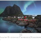 Kalender: Oktober. Nordlichter am Himmel, rote Hütten auf Felsen, großes Gebirge im Hintergrund, Meer im Vordergrund.