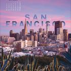 Oberer Text: "OKTOBER" mit Kalenderdaten. Mitte: Groß "SAN FRANCISCO USA". Skyline bei Sonnenuntergang mit Pflanzen im Vordergrund.